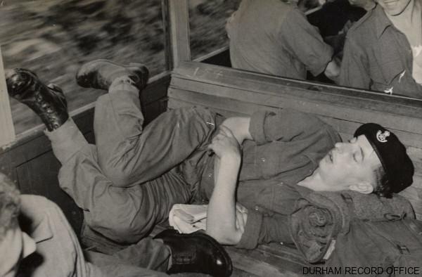Private Appleby, 1st Battalion DLI, fast asleep on the train north from Pusan, Korea, September 1952. Image © Durham Record Office (D/DLI 7/915/1(6))